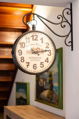 a clock hanging on a wall next to a picture at Clizia Holiday in Campofelice di Roccella