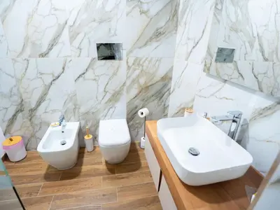 a white bathroom with a sink and a toilet at Amuri Luxury Palermo centro in Palermo