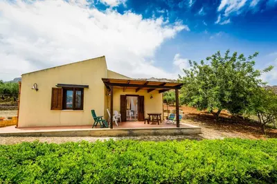 a small house with a porch and a patio at Villa del Carrubo in Castellammare del Golfo in Castellammare del Golfo