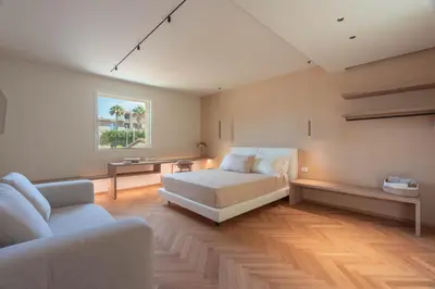 a bedroom with a bed and a couch at Ammare Luxury Villa by Le Dhome Sicily in Trappeto