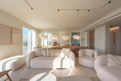 a living room with two white chairs and a table at Ammare Luxury Villa by Le Dhome Sicily in Trappeto