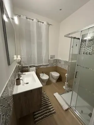 a bathroom with a sink and a shower and a toilet at Isola delle Femmine vacation home in Isola delle Femmine