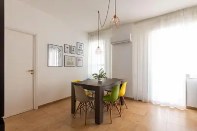 a black leather couch in a living room with a table at Vittorio Veneto Apartment by Wonderful Italy in Palermo
