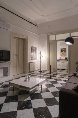 a living room with a black and white checkered floor at Large two-room apartment within walking distance of the Teatro Massimo in Palermo