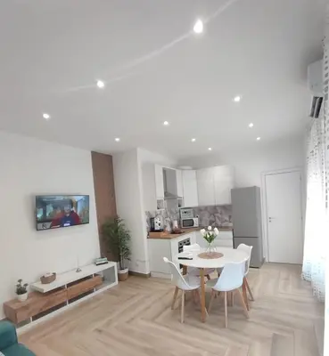 a white living room with a table and chairs at La casa di Zucchero in Monreale