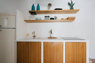 a kitchen with wooden cabinets and a sink at Sea House - Suite vista mare in Terrasini