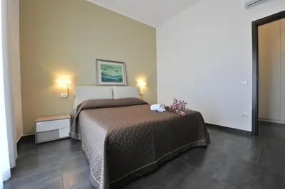 a bedroom with a bed with a teddy bear on it at Case Mistretta in Altavilla Milicia
