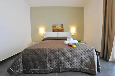 a bedroom with a bed with two stuffed animals on it at Case Mistretta in Altavilla Milicia