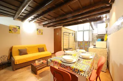 a living room with a table and a yellow couch at Ballarua in Palermo