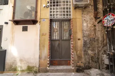 an old building with a door on the side of it at Ballarua in Palermo
