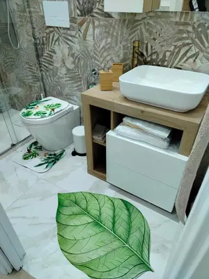 a bathroom with a toilet and a leaf on the floor at Casa mattya in Palermo