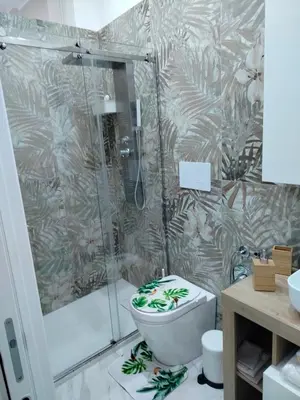 a bathroom with a shower and a toilet with agiene at Casa mattya in Palermo