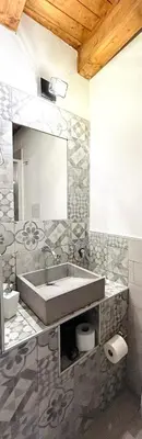 a bathroom with a sink and a mirror at La Casetta in Piazza in Palermo