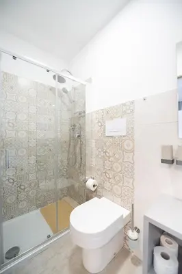 a bathroom with a shower and a toilet and a sink at Villa Amelia in Castellammare del Golfo