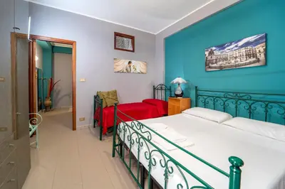 a bedroom with a bed and a blue wall at Animami Mare in Castellammare del Golfo