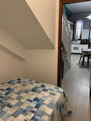 a bedroom with a red bed with a lamp on a table at Animami Mare in Castellammare del Golfo