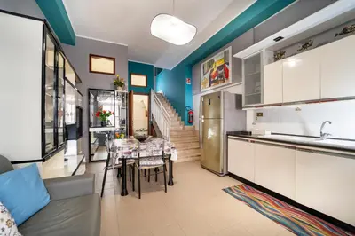 a kitchen and dining room with a dining table at Animami Mare in Castellammare del Golfo