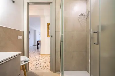 a shower with a glass door in a bathroom at Centoquaranta Apartment in Terrasini