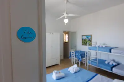 a room with two bunk beds and a mirror at Donna Rosalía Apartments in Trabia