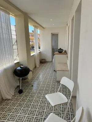 a room with chairs and a desk and a window at Appartamento sulla Spiaggia in Alcamo
