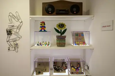 a shelf with three clear containers filled with toys at MAD Bed & Breakfast in Palermo