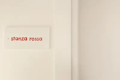 a white door with a sign that reads stanza rosa at MAD Bed & Breakfast in Palermo
