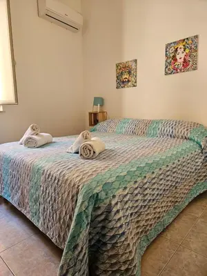a bedroom with two beds with towels on them at Al Maqueda in Palermo
