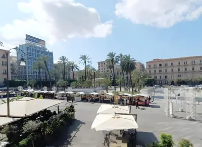 a courtyard with tables and umbrellas in a city at Domus Sicula Palermo city center in Palermo