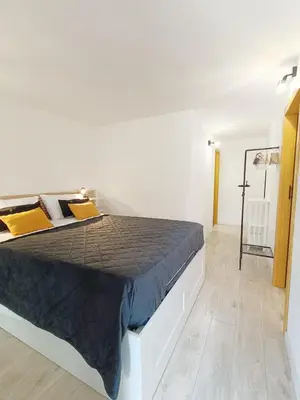 a bedroom with a large bed in a white room at Domus Sicula Palermo city center in Palermo
