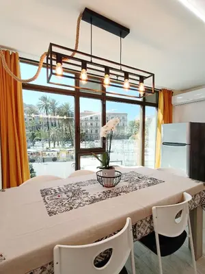 a dining room with a table and a large window at Domus Sicula Palermo city center in Palermo