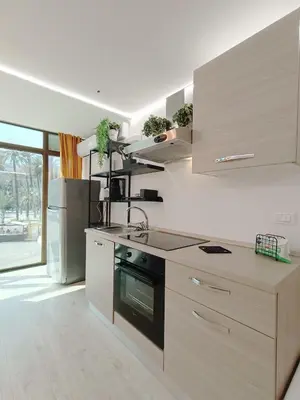 a kitchen with a sink and a stove at Domus Sicula Palermo city center in Palermo