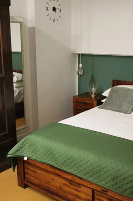 a bedroom with a bed and a clock on the wall at La casa del Cavaliere in Palermo