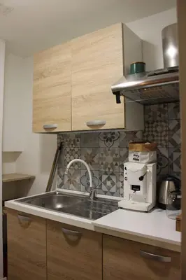 a kitchen with a sink and a coffee maker at La casa del Cavaliere in Palermo