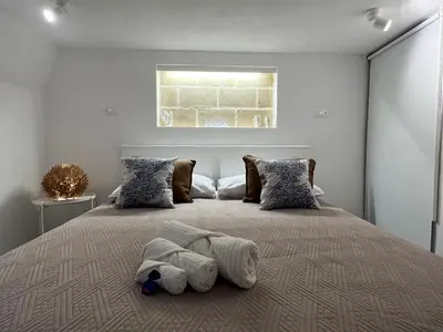a bedroom with a large bed with two pillows at Palazzo dei Duchi D'Amico - Apartment -