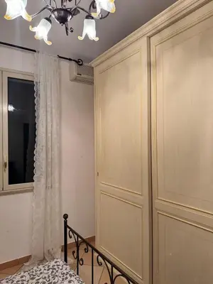 a bedroom with a bed and a chandelier at Villa Altavilla in Altavilla Milicia