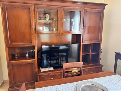 a large wooden entertainment center with a television in it at Villa Altavilla in Altavilla Milicia