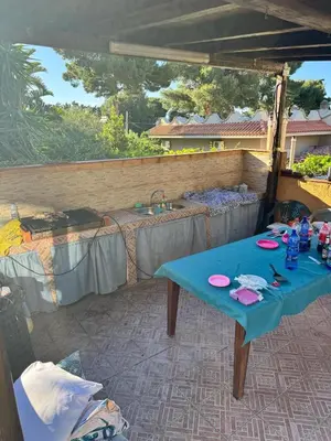 a patio with a blue table and a sink at Villa Altavilla in Altavilla Milicia