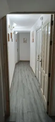 an empty hallway with white walls and wood floors at Beneath the Castle in Corleone