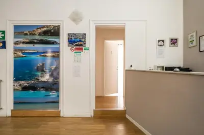 a hallway with a door with a picture on the wall at B&b Glamour in Palermo