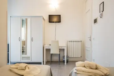 a bedroom with a desk and a bed and a table at B&b Glamour in Palermo
