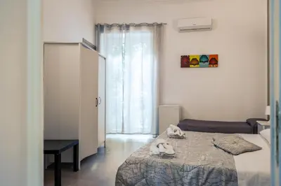 a bedroom with a bed and a window at B&b Glamour in Palermo