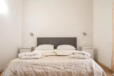 a bedroom with a bed with two towels on it at B&b Glamour in Palermo