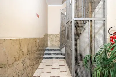 a staircase with a metal gate in a room at B&b Glamour in Palermo