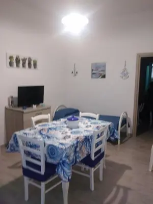 a dining room table with a blue and white table cloth at Casa Ferdinando e Maria in Palermo