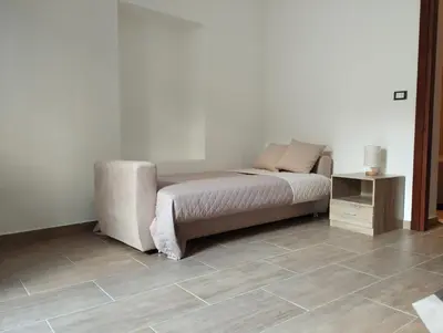 a bedroom with a bed and a side table at Corleone bed and breakfast in Corleone