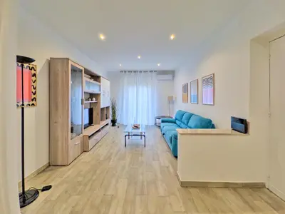 a living room with a blue couch and a tv at Casa Belsito in Palermo