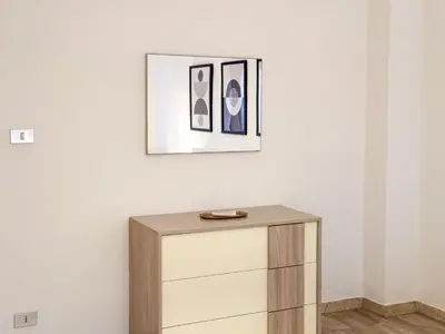 a dresser in a room with a picture on the wall at Casa Belsito in Palermo