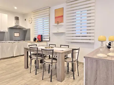 a kitchen and dining room with a table and chairs at Casa Belsito in Palermo