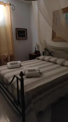 a large bed with two pillows on top of it at Casa vacanze dispensa San Pietro in Calatafimi