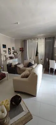 a living room with a white couch and a table at Casa vacanze dispensa San Pietro in Calatafimi